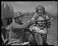 Private W.S. Pond gives food to Peggy Ann Duffy, Glendale, 1936