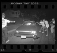 Police with guns drawn, surrounding drug suspect in Inglewood, Calif., 1988