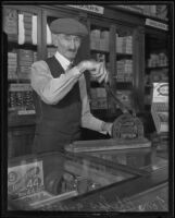 Tom Phelps cutting cigars in cigar shop, Los Angeles, 1935