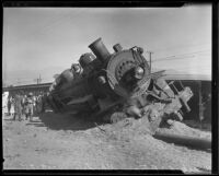 Close-up of derailed engine half-buried in ground and other train cars, Glendale, 1935