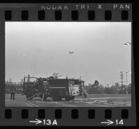 Firefighters watch from their fire truck as President Johnson's helicopter approaches Century Plaza, 1967