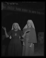 Bishop Nekona raises her palms to the sky as Sister Muriel watches in the ruins of the headquarters of Fountain of the World, 1958