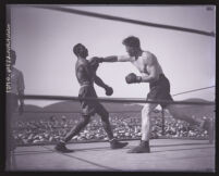 Boxer Tiger Flowers deflecting a blow from Eddie Huffman, Los Angeles, 1926