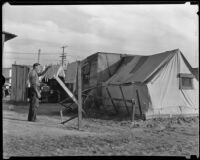 Resident of Hooverville hangs wash to dry, Los Angeles, 1930s