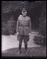 John R. Quinn in his military uniform smiling at the camera in front of his home, Los Angeles, 1929