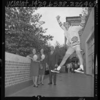 University of California, Berkeley yell leader, Jamie Sutton performing cheer at Alumni luncheon, 1964