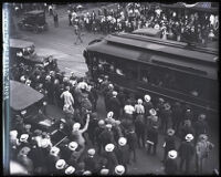 Striking Red Car workers in front of the Pacific Electric building approaching a street car, Los Angeles, 1919