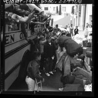 Group of boys boarding bus and loading their luggage for Green Oak Ranch Boys' Camp, Calif., 1964