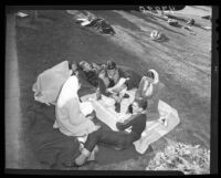 Students play cards while waiting in line for Rose Bowl tickets, 1946