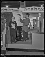 W. A. Ferguson, cartoonist, draws a picture of contest winner, Harold Dowit at the Food and Household Show, Los Angeles, 1932