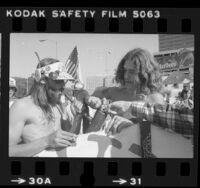 Three men lighting peace pipe filled with marijuana during demonstration for legalizing marijuana in Los Angeles, Calif., 1981