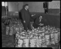 Captain Eddie Slaughter and Lieutenant G. E. Fisher prepare food donations for Christmas, Los Angeles, 1935