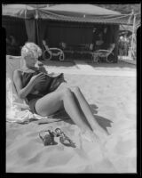 Janet Chandler reads a book on the beach, Pacific Palisades, 1935