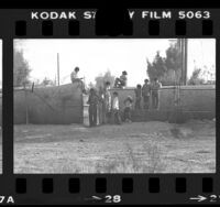 Mexican children hanging around fence along United States-Mexico border in Calexico, Calif., 1979