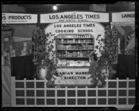 Girl stands in front of the Los Angeles Times Home Service Bureau exhibit at the Food and Household Show, Los Angeles, 1933