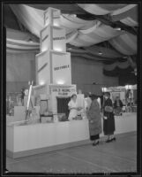 Women stand in front of a display at the Food and Household Show, Los Angeles, 1935