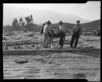 Three men and a burro in a flood-ravaged landscape, La Crescenta-Montrose, 1934