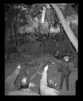 Police investigate ruins of the Fountain of the World headquarters, 1958