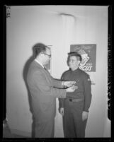 Boy Scout Albert Waterman gets Jewish Ner Tamid award from Rabbi William Kramer in Los Angeles, Calif., 1949