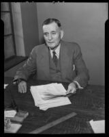 Bill Lane, owner of the Hollywood Stars baseball team, seated at a desk, Los Angeles, 1935