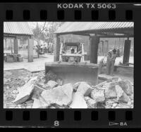 Bulldozer clearing rubble of demolished restrooms at Gladys Park on Skid Row, Los Angeles, 1986