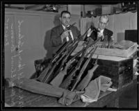 Deputy Lieutenant Harry A. Toland and Sargent Elmer Larson with guns used in Monte Carlo robbery, 1935