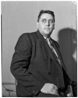 Ned Cronin, Los Angeles Daily News sports editor, posing in a chair, Los Angeles, January 1940