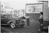 Drive-in waitress carrying a tray, Los Angeles, 1937