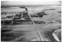 Aerial view of rushing flood waters destroying homes in North Hollywood, Los Angeles, 1938