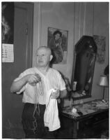 Euclide Allard, 66, holding a piece of twine and a towel used by a burglar to tie up Allard in his hotel room, Los Angeles, February 16, 1940