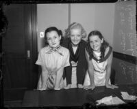 Actresses Evelyn Poe, Helen Parrish, and Phyllis Brooks pose after their film contracts are approved, Los Angeles, 1935