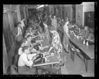 Rows of workers tabulating votes from Los Angeles, Calif. for 1942 California primary election, Los Angeles, 1942