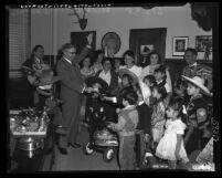 Sheriff Eugene Biscailuz with giving children from Olvera Street money for March of Dimes in Los Angeles, Calif., 1953