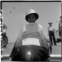 Al Pedrosa smiling in his soap box derby car, Los Angeles, 1946