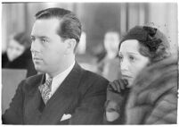 Actor Ben Lyon with his wife, actress Bebe Daniels, during a trial for Albert F. Holland, who wrote 150 love letters to Daniels, Los Angeles, 1933