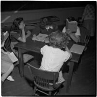 Five girls sitting around a table in a classroom, Los Angeles, March 1946