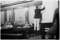 Public defender Ellery Cuff indicating a point on a map at his client Albert Dyer's murder trial, Los Angeles, 1937