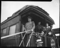 President Franklin D. Roosevelt and Eleanor Roosevelt greet crowd from a train as they arrive, Los Angeles, 1935