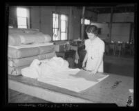 Woman cutting clothing patterns at a California State Emergency Relief Administration program, 1934