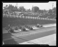 Motorcycles on Arroyo Seco Parkway as military trucks exit at dedication of the highway, Los Angeles, 1940