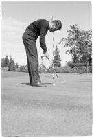 LA Daily News city editor Charles Judson demonstrates improper golf swings for a tutorial series with golfer Fay Coleman. Circa 1940