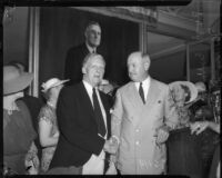 Senator Culbert L. Olson shakes hand with Postmaster General James A. Farley at a convention for the California Federation of Democratic Women's Clubs