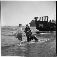 Two military officers wade through the water during the Army-Navy maneuvers that took place off the coast of Southern California in late 1946