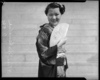 Miss Lil Tokio winner Alice Watanabe poses with a fan in a traditional kimono in honor of the Nsei festival, Los Angeles, 1935