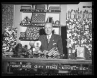 Unidentified man at store counter, surrounded by items crafted by inmates of San Quentin Prison's industrial program, Calif., circa 1948