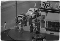 Aerial view of pedestrians and Owl Drug on the corner of Hollywood and Vine, Los Angeles, 1940