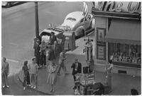 Aerial view of pedestrians and Owl Drug on the corner of Hollywood and Vine, Los Angeles, 1940