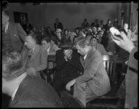 Louis Rude Payne, with father Lucius Payne at his side, at his inquest for the murder of his mother and brother. June 6, 1934