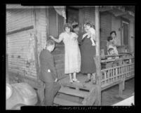 Women and children on porch in slums of Los Angeles, circa 1937