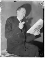 Murder suspect Robert S. James smoking and reading a newspaper in his jail cell, Los Angeles, 1936